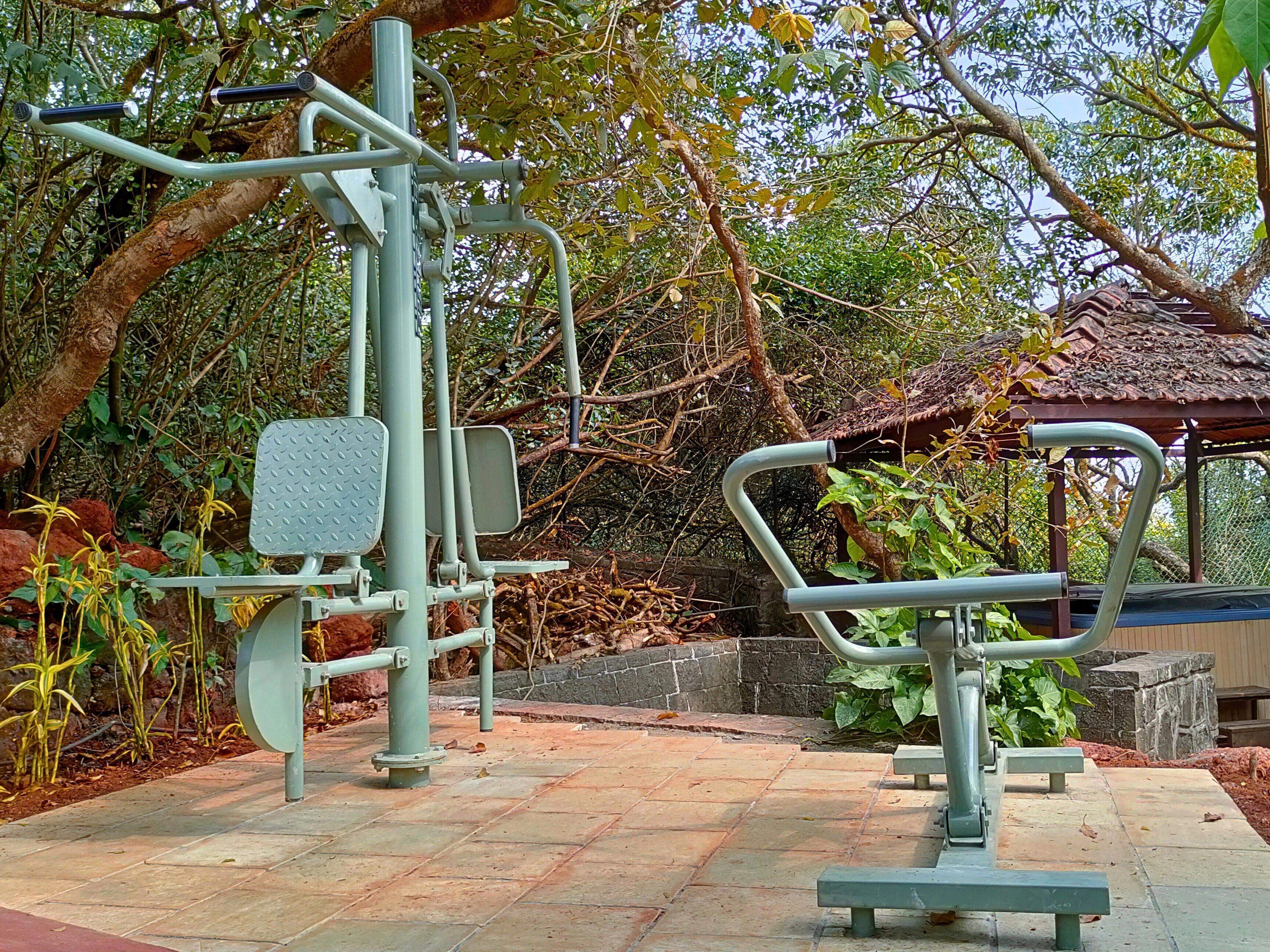 Outdoor fitness zone at Ramsukh Resort, featuring exercise equipment surrounded by nature.